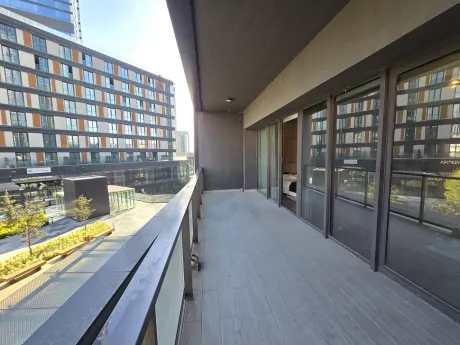 Spacious and airy balcony of a modern residence apartment with a city view.