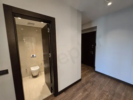 Bathroom area of a luxury residence with modern fixtures and stylish ceramic tiling.