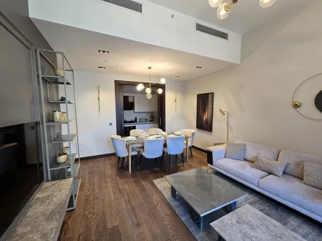 Spacious and modern designed empty living room area with large windows.