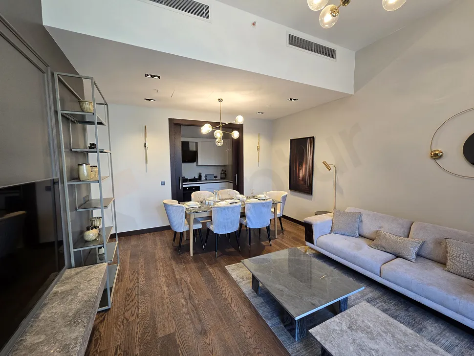 Spacious and modern designed empty living room area with large windows.