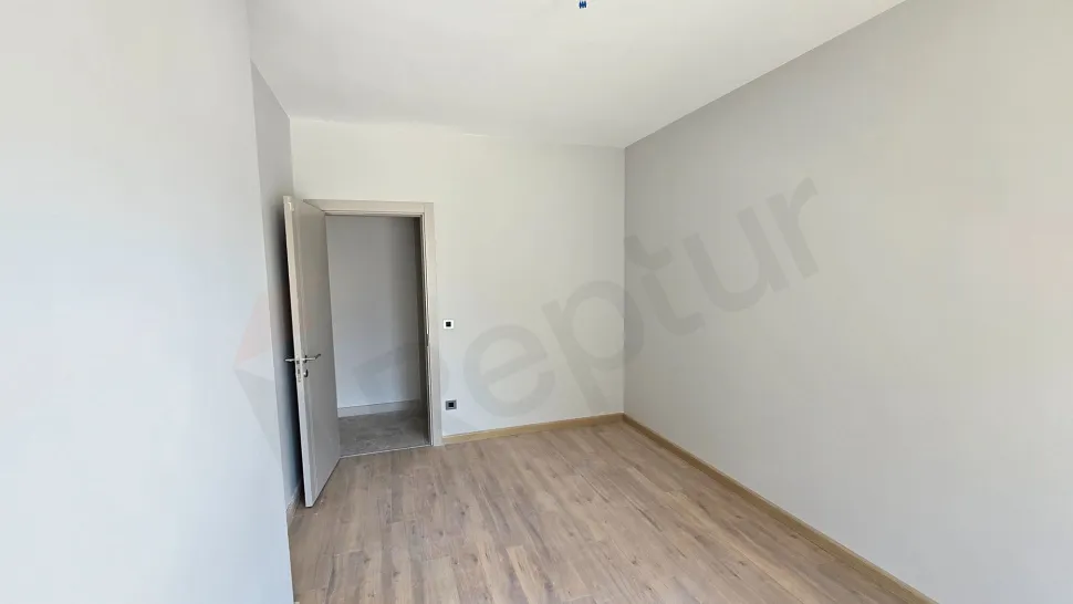 Modern and spacious bedroom interior with natural lighting and contemporary design.