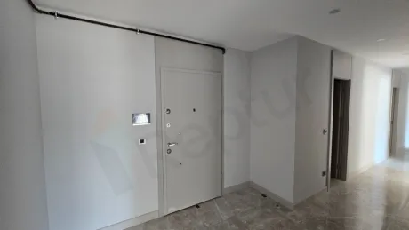 Entrance door and hallway area of an apartment in a modern building.