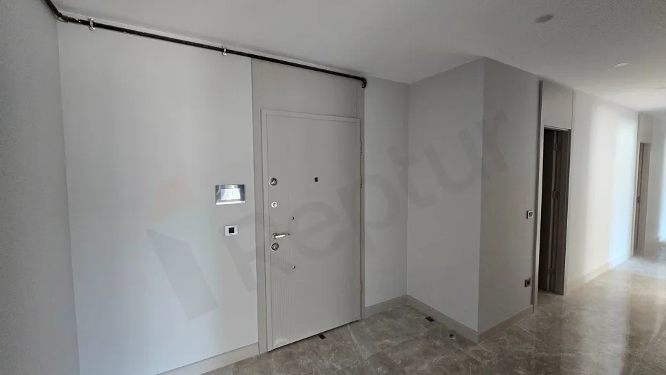 Entrance door and hallway area of an apartment in a modern building.