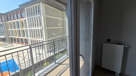 Large balcony area and city view in a modern building.