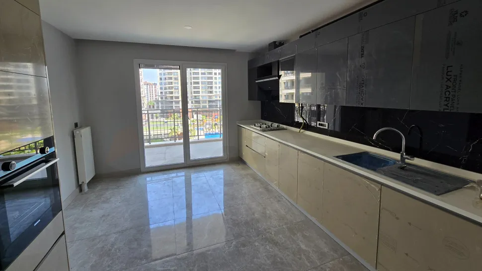 A bright luxury apartment kitchen with a modern and spacious design.