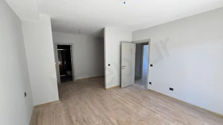 A view of a modern and spacious bedroom with large windows and a bright design.