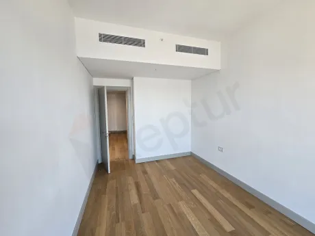 Modern designed, bright bedroom with large windows.