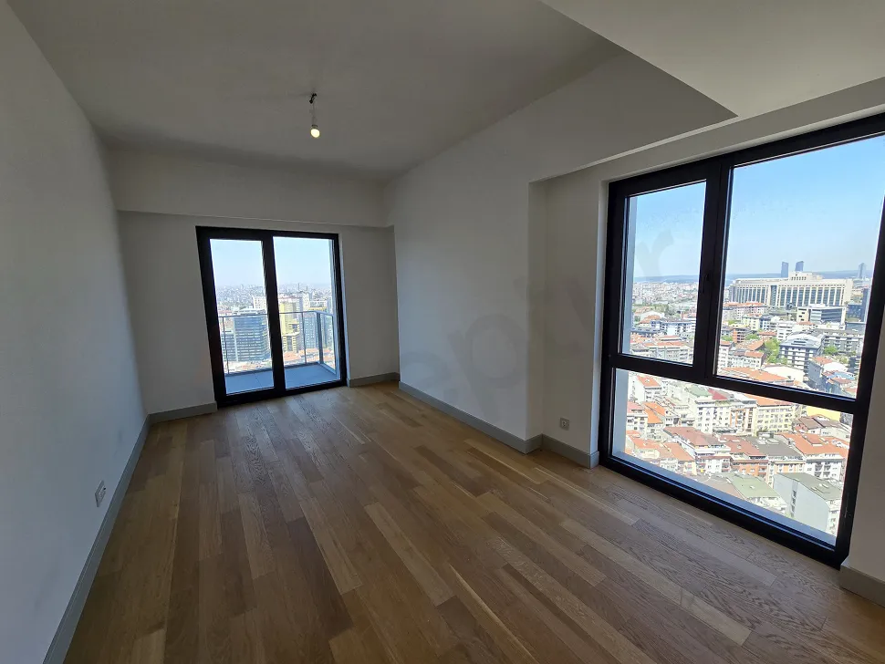 Bright living room area with large windows and city views, featuring modern architecture in Sisli.