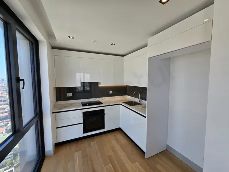Modern designed kitchen area with built-in cabinets and spacious countertops in a luxury apartment in Sisli.
