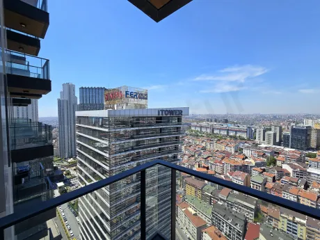 A modern and spacious apartment balcony with railings overlooking the city view.