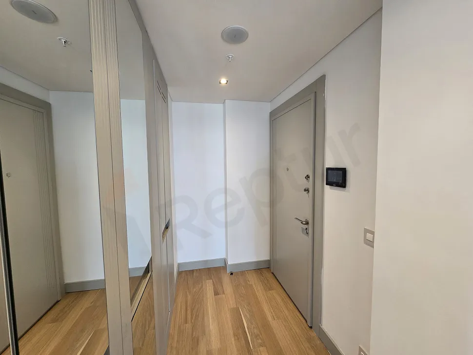 Modern entrance door and hallway of a 1+1 luxury residence apartment located in Sisli.
