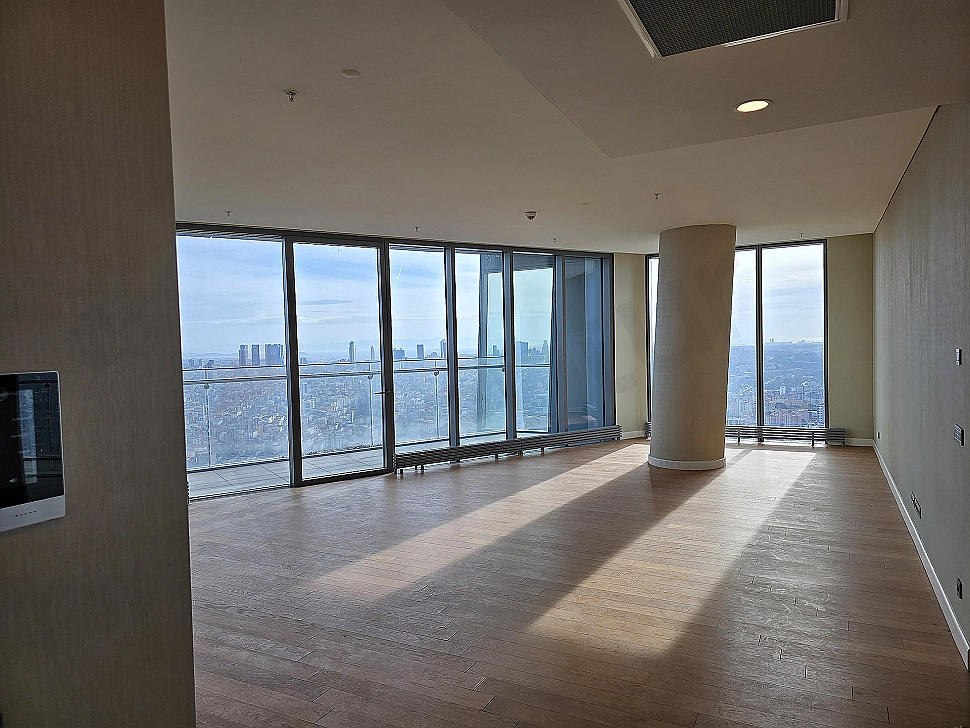 Modern living room, large windows, wooden floor, cream-colored corner sofa, fireplace, Sarıyer Istanbul.