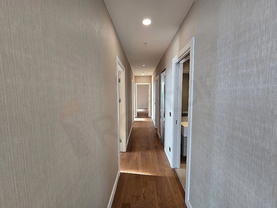 Modern illuminated, spacious and luxurious apartment corridor.