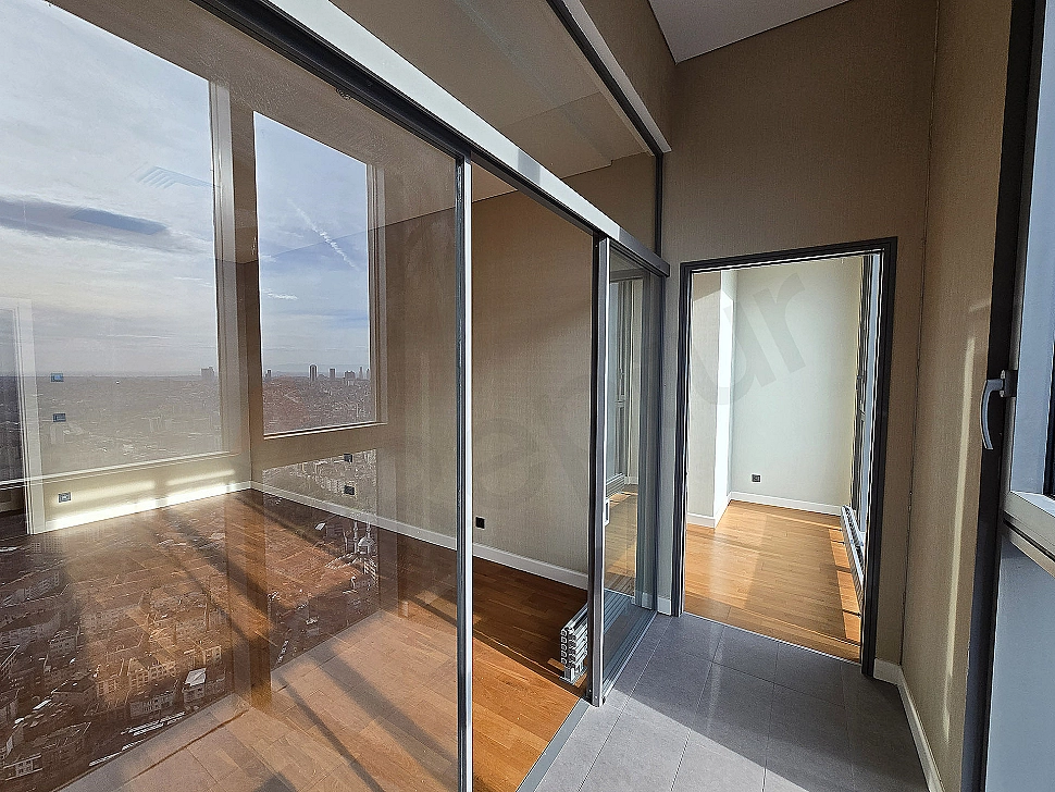 Balcony of luxury apartment with wide balcony, wooden floor, glass railing, city view.