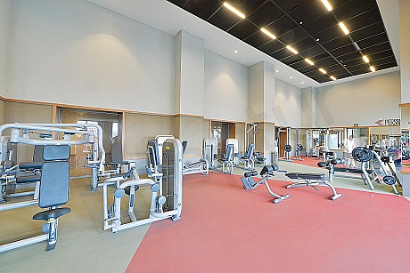 Modern gym interior, fitness equipment and bright atmosphere.