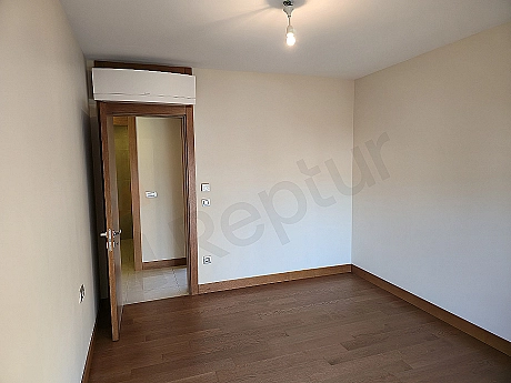 Modern bedroom interior, spacious double bed, stylish bedside tables, and decorative lighting elements.