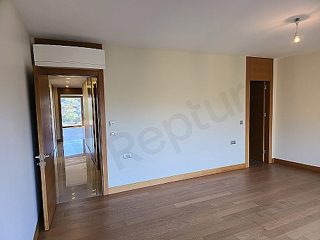 Modern bedroom interior: spacious double bed, wooden bedside tables, lampshades, carpet, window, and stylish decor.