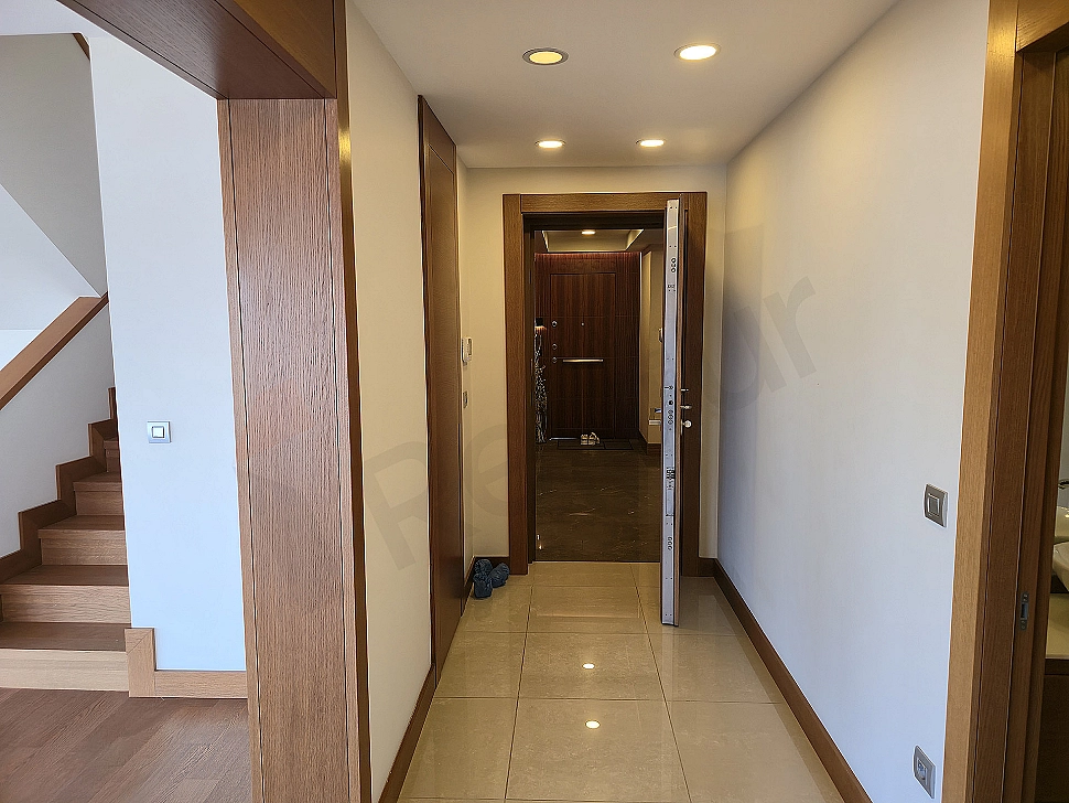 Bright and spacious duplex apartment corridor with modern design.