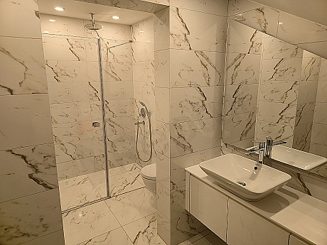 Luxury bathroom interior, modern design, wide sink, mirrored cabinet and bright atmosphere.