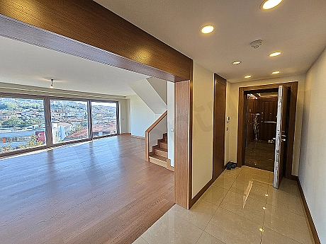 Entrance door of a luxury duplex apartment with modern interior detail.
