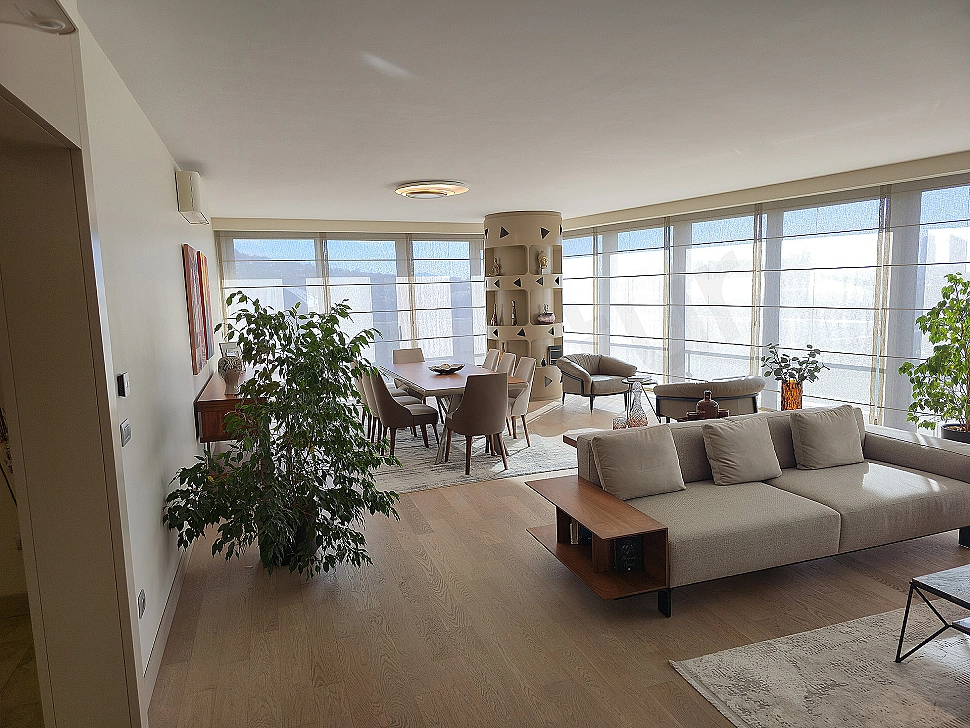 Modern living room interior with large windows, stylish furniture, and bright design.