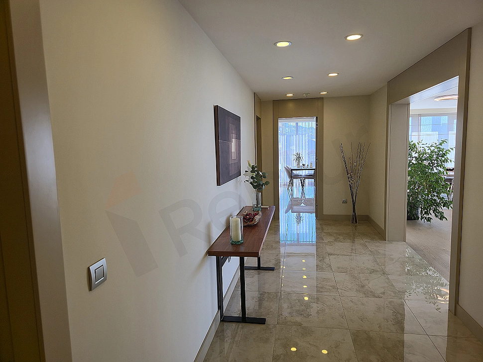 Modern designed wide corridor. Lighting details and stylish floor covering.