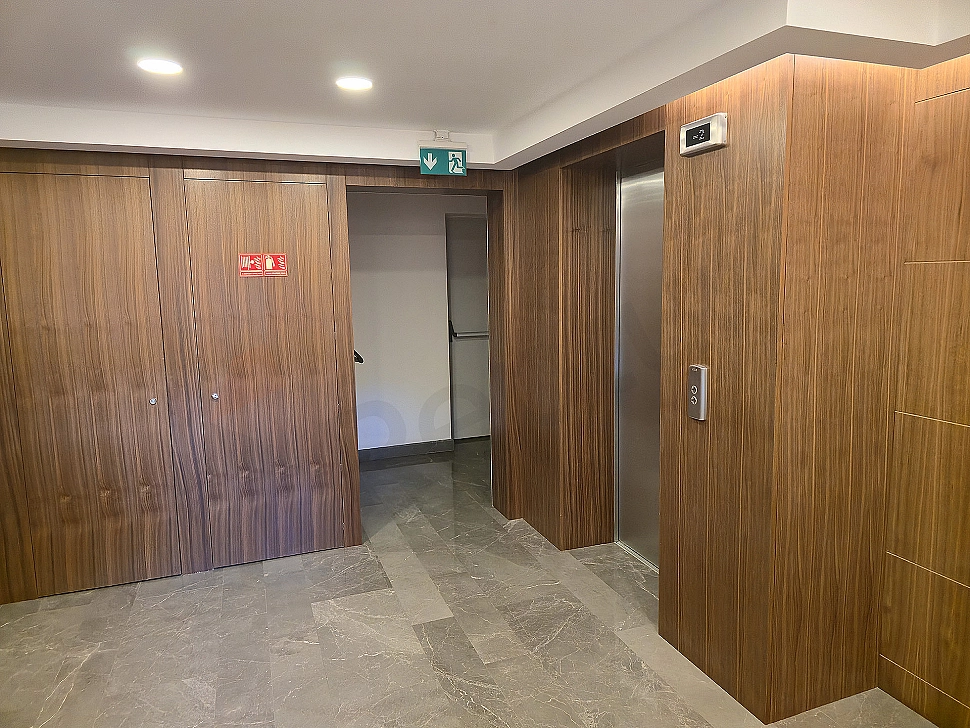 Interior of a modern elevator cabin, details of lighting and control panel.
