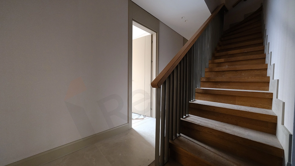 Interior view of a wooden staircase in a duplex apartment.