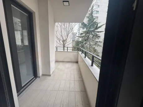 Spacious and modern apartment balcony with a city view.