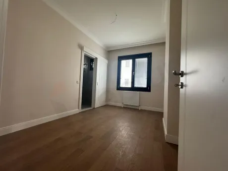 Interior view of a modern and spacious bedroom in an apartment.
