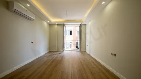 Spacious and bright bedroom area of a modern 1+1 apartment in Beyoglu, Istanbul.