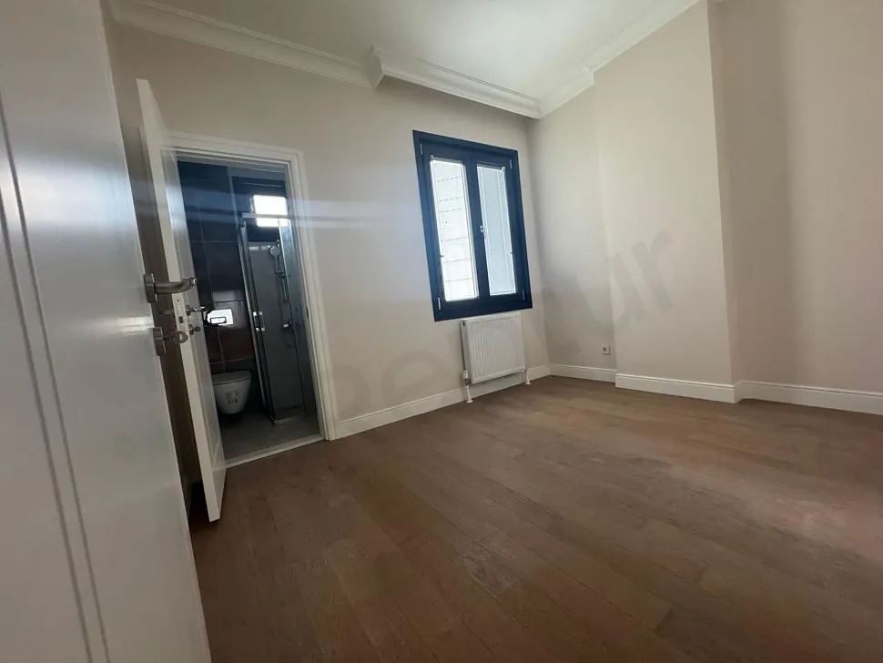 Spacious and modernly designed bedroom interior with natural light.