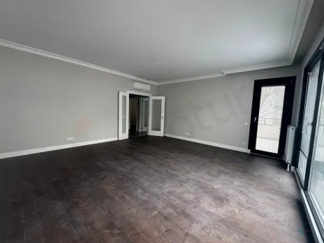 Spacious and bright living room area with large windows.