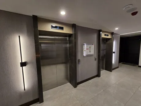 Modern elevator cabin and doors inside a luxury residence building.