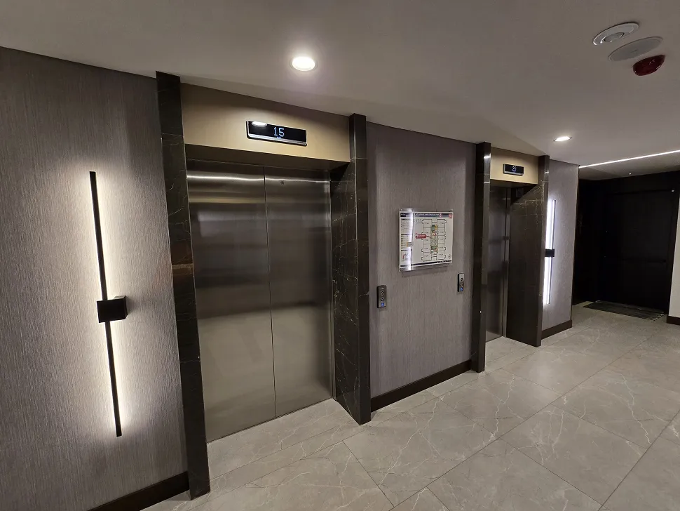 Modern elevator cabin and doors inside a luxury residence building.