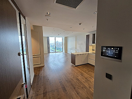 Modern apartment entrance hall with wooden door, lighting, and stylish design details