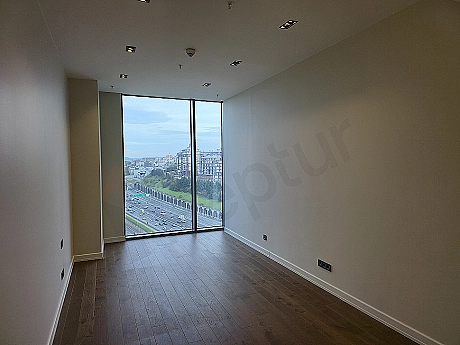 Bright and stylish bedroom with modern design and large windows.
