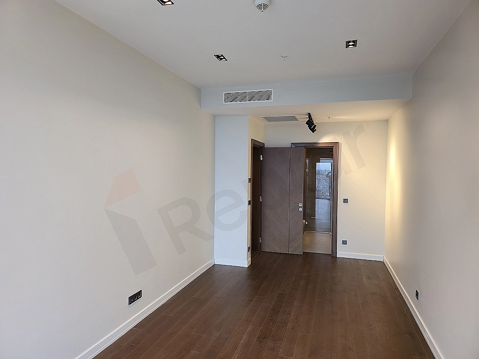 Modernly designed stylish bedroom with large windows and wooden details