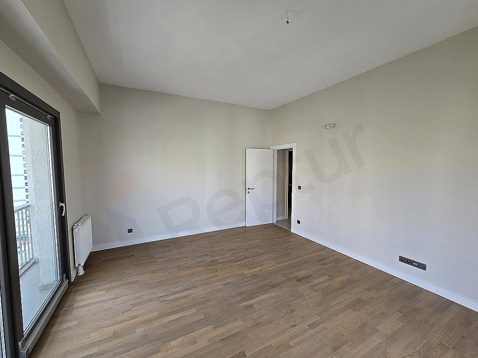 Modern living room interior, light colored walls, wooden parquet flooring, gray corner sofa and decorative lighting