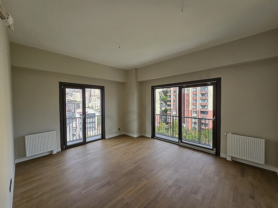 Living room of an unfurnished 2+1 apartment with a modern design.