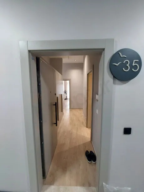 Entrance hallway and main door of a modern apartment.