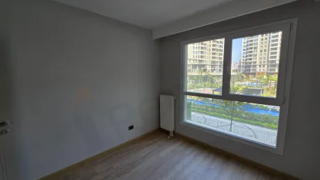 Modern and bright bedroom interior with large windows.