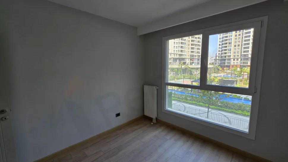 Modern and bright bedroom interior with large windows.