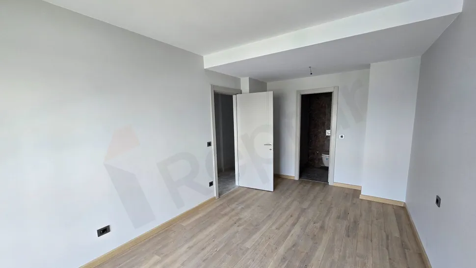 View of a modernly designed, spacious, and airy bedroom.