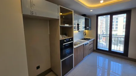 Modern and spacious kitchen area, large kitchen countertop and cabinet details.