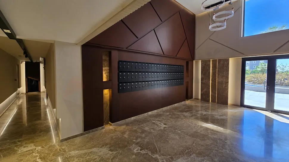 Spacious and stylish residence lobby with modern interior design and reception area.