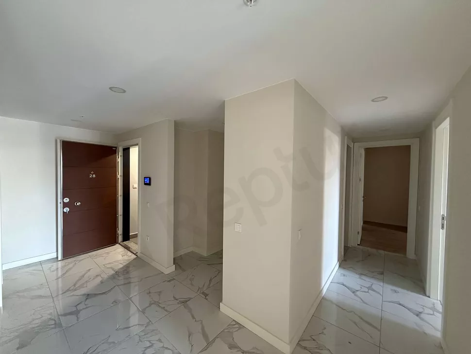 Interior view of a modern and spacious apartment corridor.