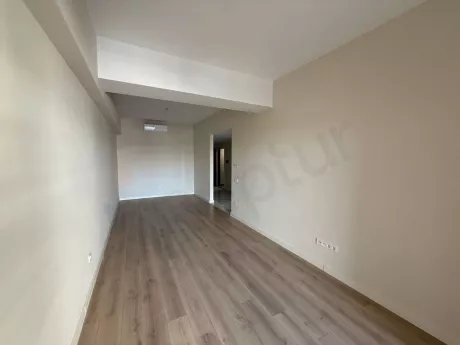 View of a spacious and bright living room with modern architecture and large windows.