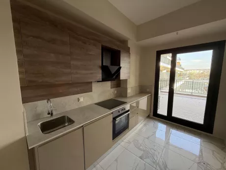 Modernly designed, spacious and bright kitchen area.