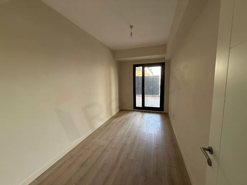 Modern and spacious bedroom interior with large windows and natural light.